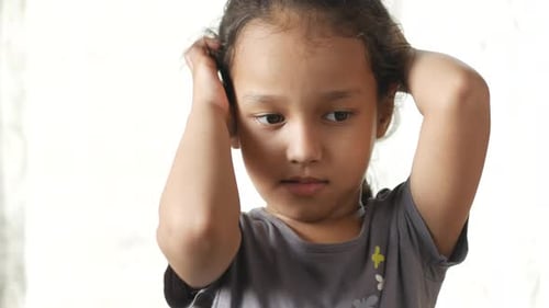 Young Girl Scratching Her Head Close Up