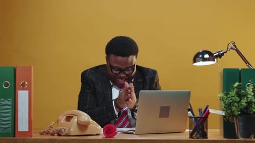 Professional Individual Engaged in a Contemporary Office Setting Utilizing a Laptop for Work