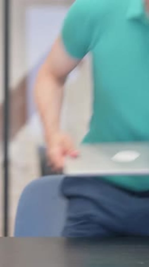 Man Arrives and Opens Laptop Ready to Work
