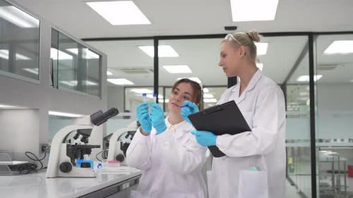 Scientists Working with Microscope in a Lab