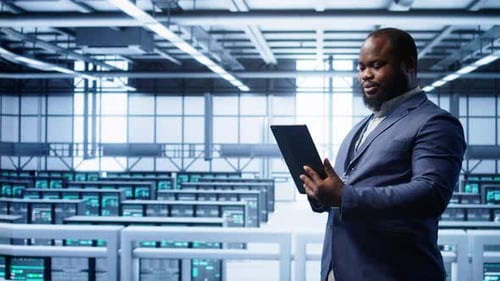 Professional Man with Tablet in Server Room