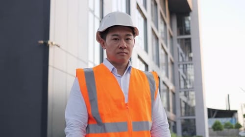 Construction Worker with Hard Hat at Building Site