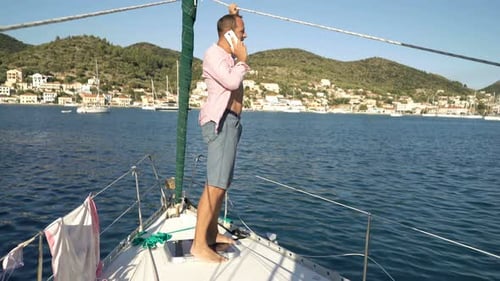 Young Man Talking on Cellphone While Sailing Boat on Sea Adult