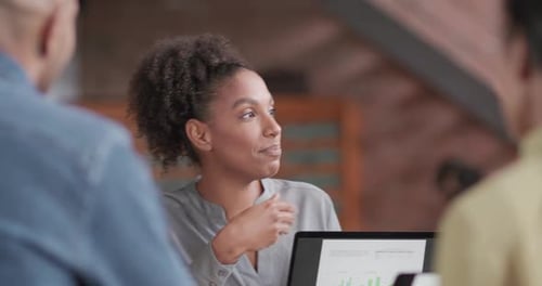 Business Woman Presenting at Meeting in Creative Office using Laptop Technology