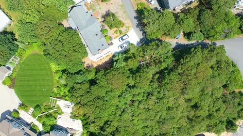 Drone Bird’s Eye View of Beach Houses, Sandy Shoreline, and Turquoise Waves