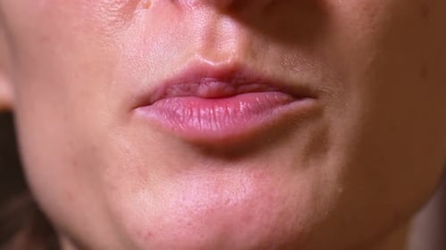 Close-up of mouth of woman talking to camera