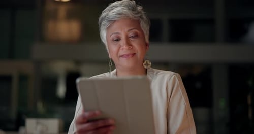 Corporate, mature woman and tablet at night in office, communication and company feedback