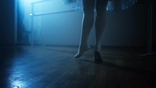 Ballerina Practicing Foot Movements in Ballet Studio