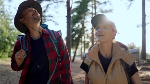 Portrait of Happy Male and Female Tourists Walking Together in Forest Hiking Athletic People