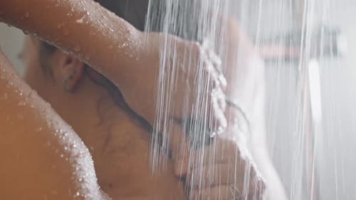 Woman Washing Long Dark Hair in Shower