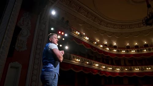 Young actor performing a monologue in a theater. Showman.