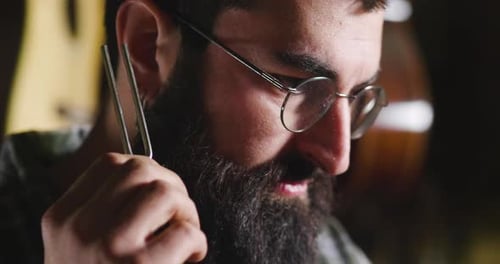 Dans son laboratoire, un liutiste fabrique des guitares de haute qualité pour les musiciens, en travaillant du bois précieux.
Concept