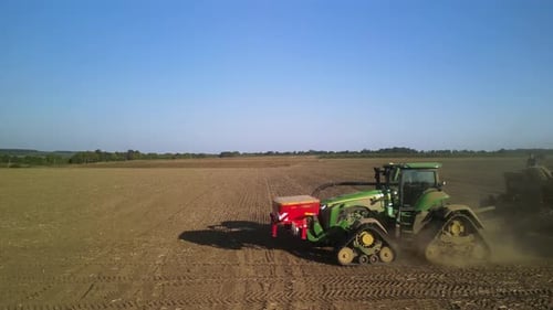 Tractor on the field seeding wheat