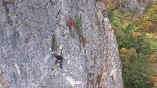 Man Climbing Up the Side of a Mountain