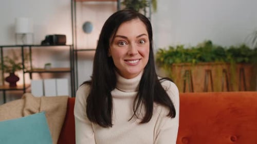 Smiling Woman Talking and Looking Directly at Camera
