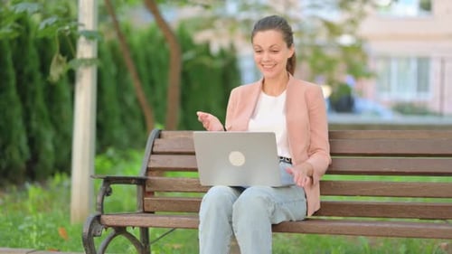 Woman having a video call in the park