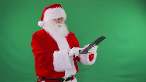 Santa Using Tablet Against Green Screen