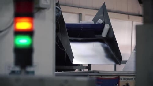 Plastic Containers Moving on Conveyor Belt in Factory