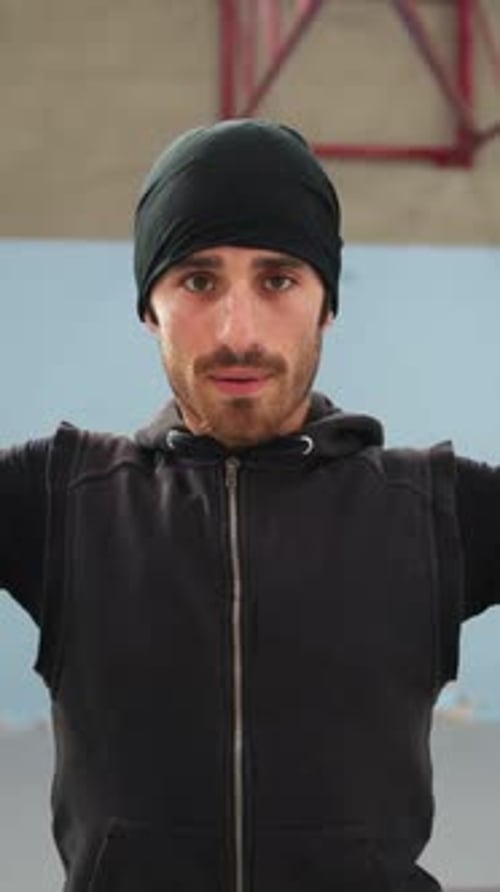 Man Stretching Arms Inside Urban Gym Setting