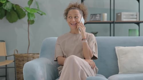 Woman Talking on the Phone on the Couch