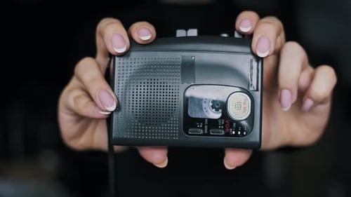 Woman Holding 2000s Style Portable Cassette Player