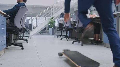 Modern open office with colleagues and skateboarder