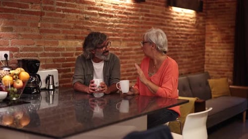 Senior Couple Having Coffee in Cozy Kitchen