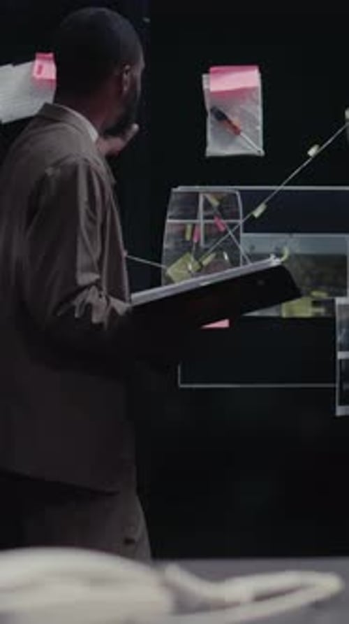 Detective Examining Evidence Board in Dark Room