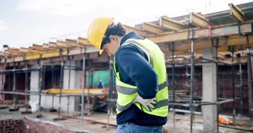 Construction, back pain or man on site with strain, joint sprain or labor injury in building