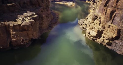 Exploring the Serene Beauty of a River Winding Through Rocky Canyon Landscape