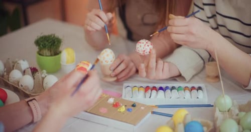 Close Up of Family Painting Easter Eggs
