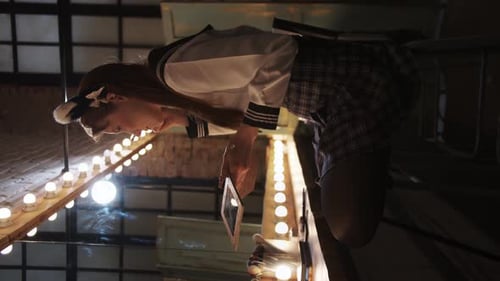 Woman Applies Make-Up at Night