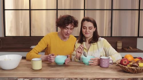 Affectionate Couple Enjoying Cereal Breakfast at Home
