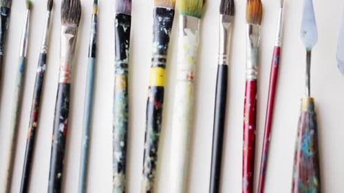 Art Creativity and Tools Concept - Messy Palette Knives and Paintbrushes Activity
