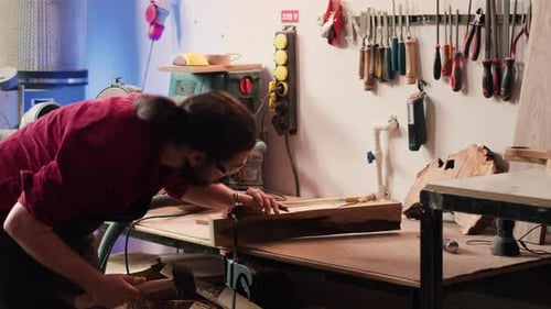 Woodworker Using Bench Vise to Hold Lumber Block Carving Intricate Designs
