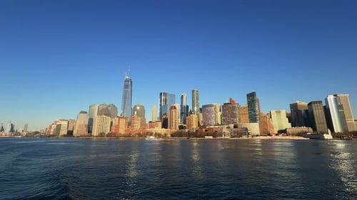 Moving boat view Lower Manhattan skyline sunny day, New York, USA