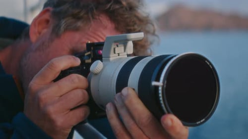 Professional Filmmaker On A Ferry At Sunset