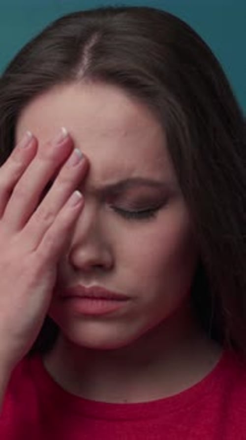 Woman Massaging Temples due to Headache Pain