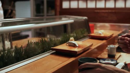Sushi Chef Serves Couple at Restaurant Counter