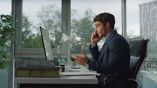 Confident financial analyst talking mobile in office discussing marketing project