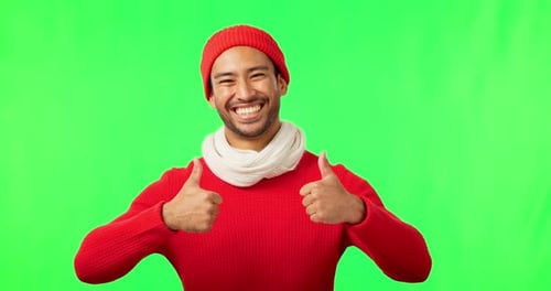 Green screen, face and happy man with thumbs up for winter sale, fashion