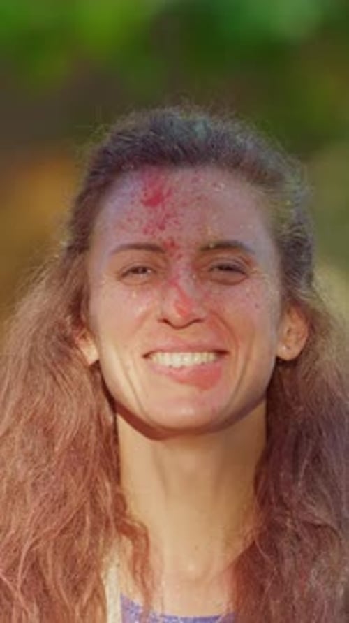 Vertical Video Girl at Indian Holi Festival in Colorful Dry Paints Rejoices and Enjoys Fun