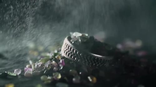White gold ring set with diamonds is a luxurious jewelry on small rocks, water droplets falling.