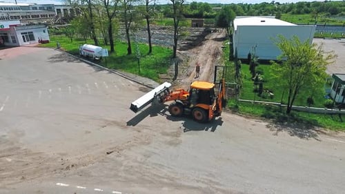 Working machine on construction. Aerial view of tractor working at construction site