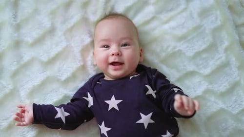 Adorable Baby Smiling on Soft Blanket
