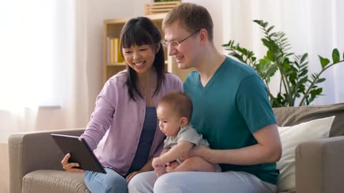 Smiling Family Video Calling on Tablet at Home