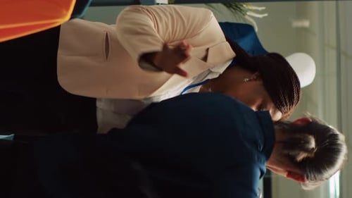 Customers Browsing Sale Racks in Clothing Store