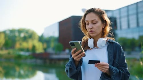 Woman Shopping Online with Phone and Credit Card