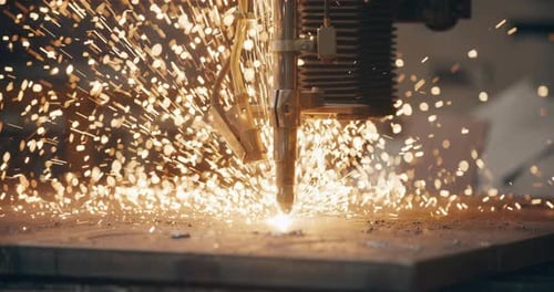 Machine Cuts Metal with Sparks in Factory