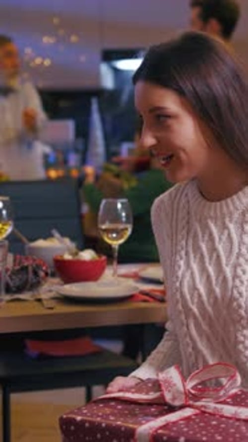 Woman Receives Gift at Holiday Celebration